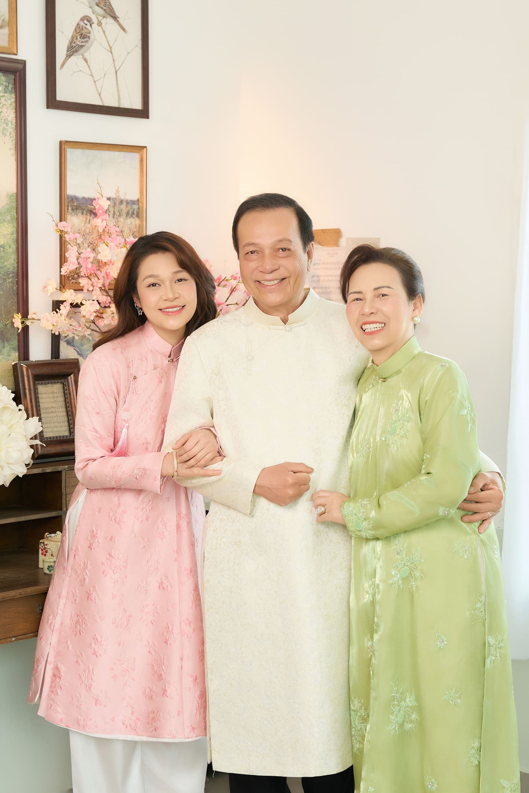 Gia đình Yen Nguyen mặc áo dài hồng, trắng và xanh đứng gần nhau trong ngày đoàn tụ