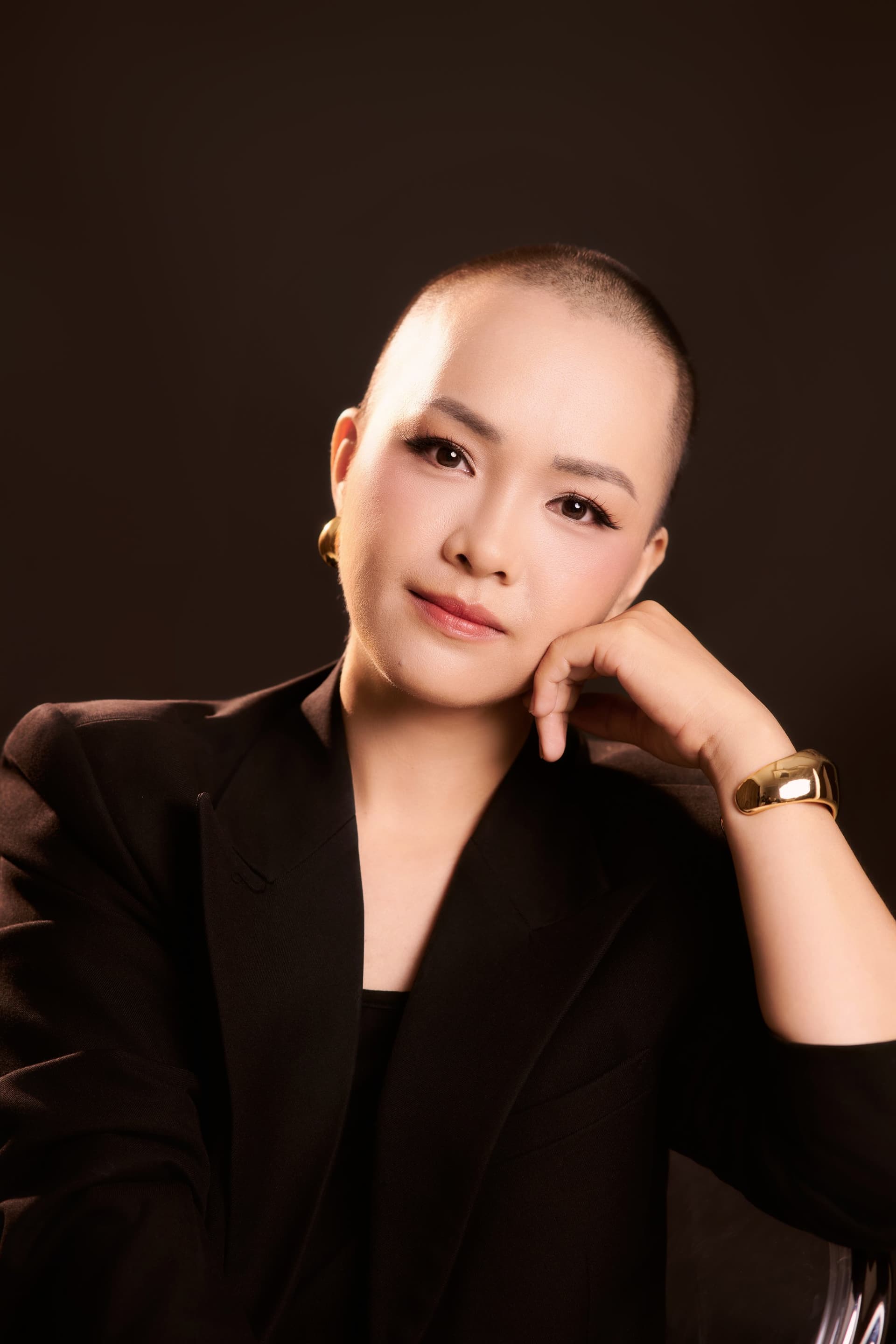 Diệu Huyền tựa cằm, biểu cảm bình thản trên nền trầm.