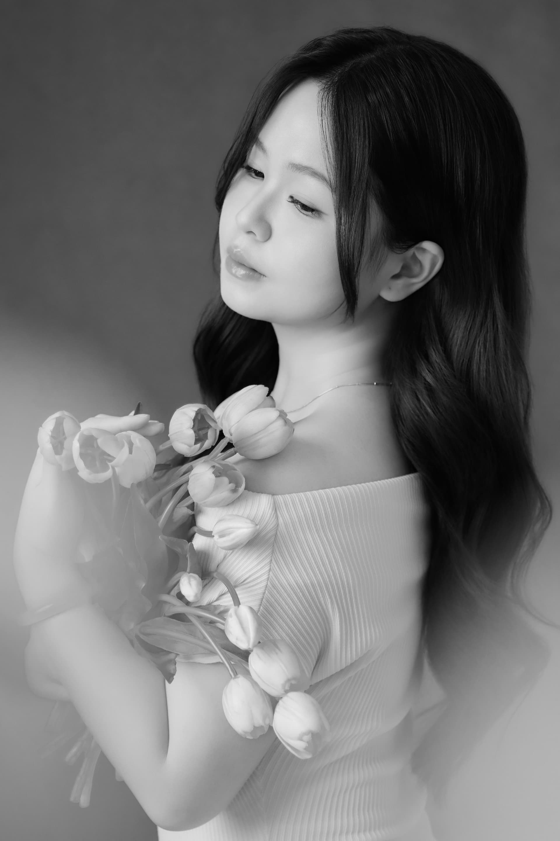 Bức ảnh chụp đôi bàn tay Linh đang khẽ chạm nhẹ vào đóa hoa hồng nhạt đầy tinh tế