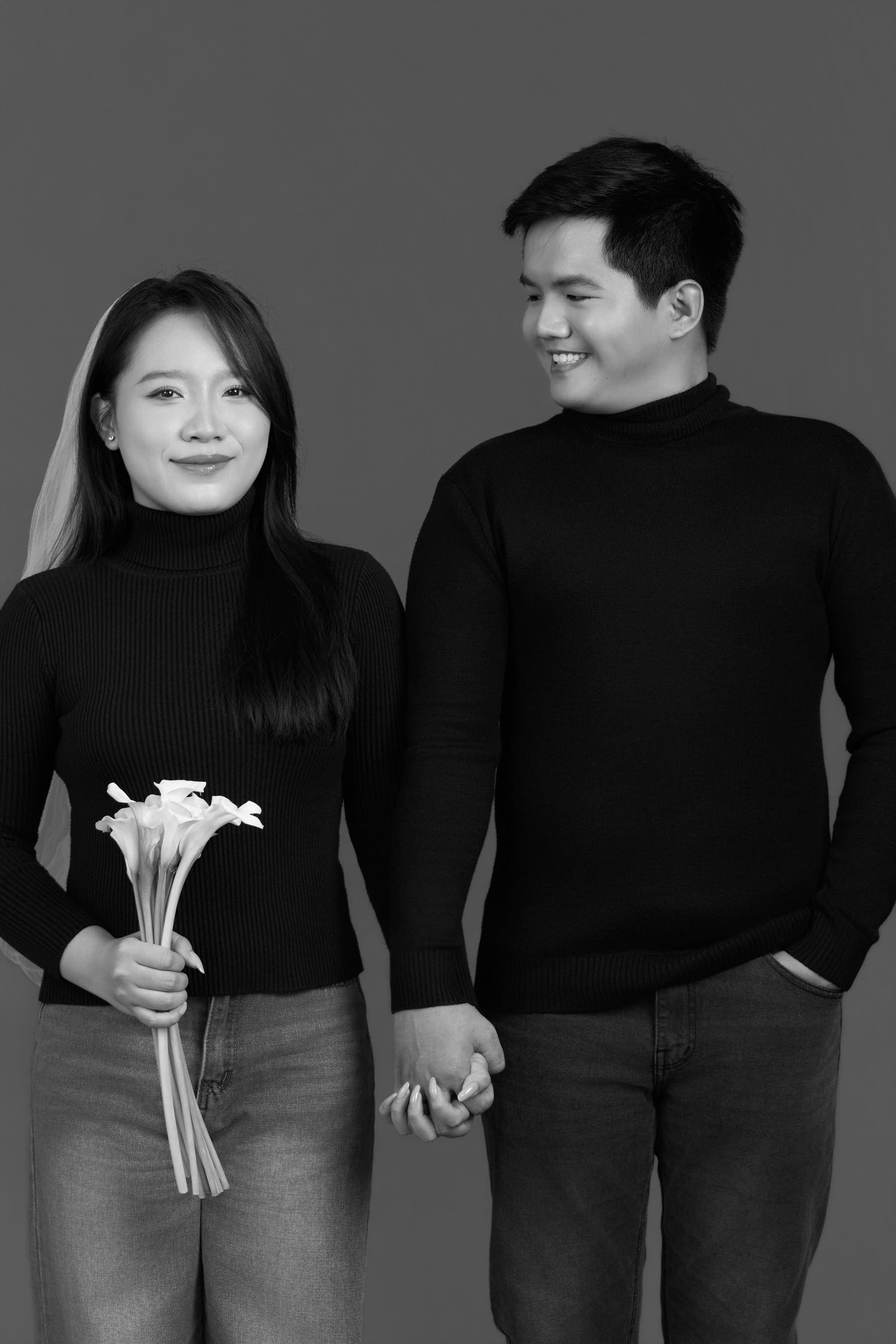 Vợ chồng Bích Trâm ôm bó hoa trắng, đứng sát bên nhau, mốc kỷ niệm hai năm chung một mái nhà